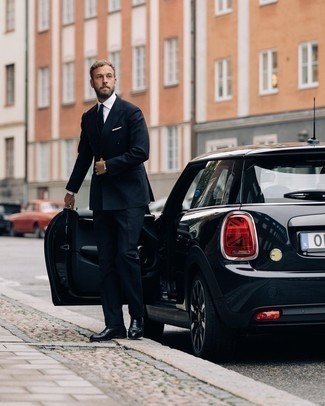 Black Tie Outfits For Men: Teaming a navy suit and a black tie is a fail-safe way to inject your wardrobe with some rugged refinement. Rev up the cool of your ensemble by sporting black leather loafers.