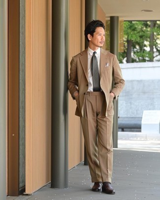 Tan Suit Outfits: This pairing of a tan suit and a white dress shirt will add alpha male essence to your outfit. Play down the classiness of this look by slipping into a pair of dark brown leather loafers.
