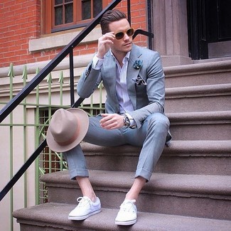 Violet Vertical Striped Dress Shirt Outfits For Men: Make a violet vertical striped dress shirt and a grey suit your outfit choice for a neat classy look. Bring an easy-going vibe to by finishing off with white leather low top sneakers.