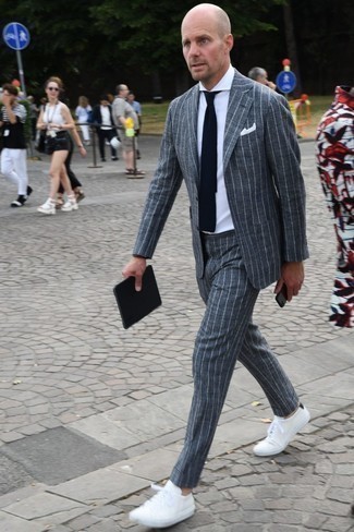 Grey Vertical Striped Suit Outfits: Consider teaming a grey vertical striped suit with a white dress shirt if you're aiming for a neat, stylish look. You can take a more casual approach with shoes and introduce white low top sneakers to the mix.