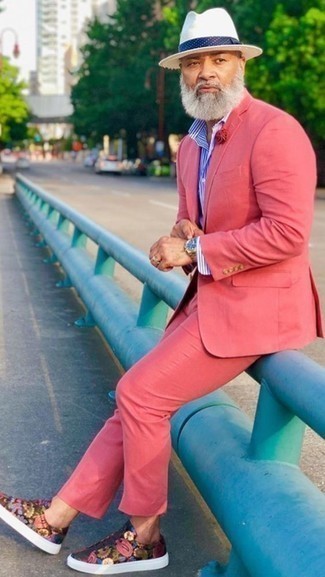 Pink Suit Outfits: A pink suit and a white and blue vertical striped dress shirt are among the unshakeable foundations of a classy menswear collection. Bring an easy-going feel to by rounding off with a pair of multi colored print leather low top sneakers.