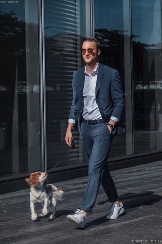 White Leather Low Top Sneakers Dressy Outfits For Men: Loving how this pairing of a navy suit and a light blue dress shirt immediately makes any guy look polished and smart. Serve a little mix-and-match magic by wearing white leather low top sneakers.