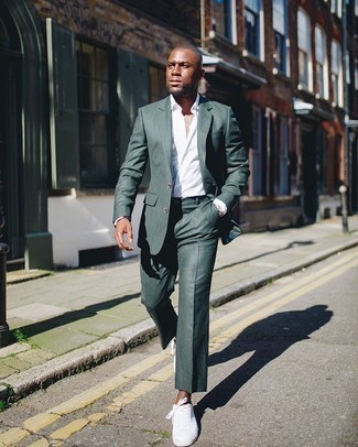 Dark Green Suit Outfits: A dark green suit and a white dress shirt are among the crucial pieces of any modern man's wardrobe. Take a more casual approach with shoes and introduce a pair of white canvas low top sneakers to the mix.