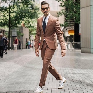 White and Navy Canvas Low Top Sneakers Warm Weather Outfits For Men: Reach for a tan suit and a white dress shirt if you're aiming for a clean-cut, fashionable outfit. Introduce a more laid-back touch to by finishing off with white and navy canvas low top sneakers.