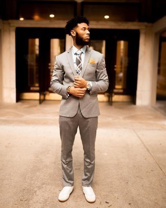 Dark Brown Plaid Tie Outfits For Men: Marry a tan suit with a dark brown plaid tie for a sharp and refined silhouette. Rounding off with white canvas low top sneakers is an effortless way to bring a more casual spin to this ensemble.