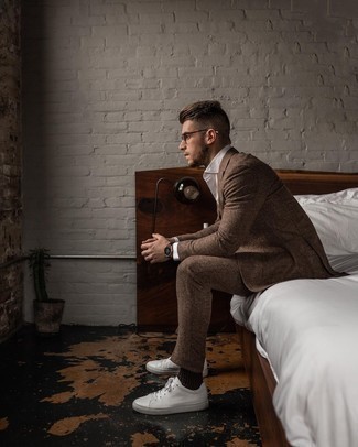 Dark Brown Wool Suit Outfits: You'll be surprised at how easy it is to get dressed like this. Just a dark brown wool suit paired with a white dress shirt. Take a more casual approach with shoes and introduce white leather low top sneakers to the mix.