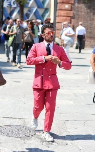 Pink Suit Outfits: You're looking at the irrefutable proof that a pink suit and a white dress shirt look awesome when you team them together in a classy outfit for today's gentleman. Add a playful vibe to your look by wearing white canvas low top sneakers.