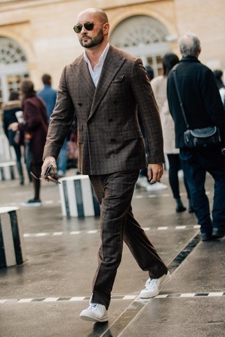 Dark Brown Plaid Suit Outfits: You're looking at the hard proof that a dark brown plaid suit and a white dress shirt look awesome when you team them up in a polished outfit for a modern man. If you want to break out of the mold a little, complete your look with a pair of white and black leather low top sneakers.