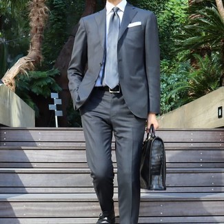 Briefcase Outfits: A navy suit and a briefcase paired together are the perfect combination for guys who appreciate neat and relaxed looks. Up this whole look by wearing black leather monks.