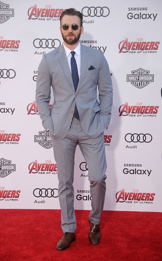 Chris Evans wearing Navy and White Vertical Striped Seersucker Suit, White Dress Shirt, Dark Brown Leather Oxford Shoes, Navy and White Polka Dot Tie