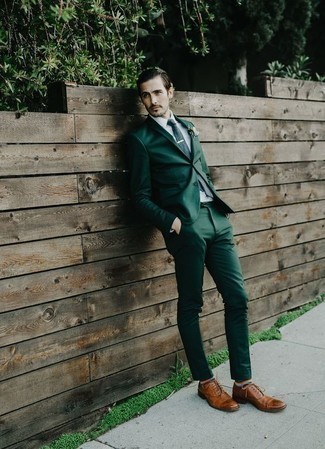 Navy Tie Outfits For Men: This classy combination of a dark green suit and a navy tie will prove your outfit coordination chops. Tone down the formality of your outfit with a pair of tobacco leather oxford shoes.