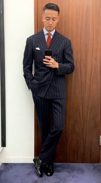 Red Tie Outfits For Men: Go for a navy vertical striped suit and a red tie for masculine elegance with a clear fashion twist. Take an otherwise mostly dressed-up outfit down a more laid-back path by finishing off with a pair of black leather oxford shoes.