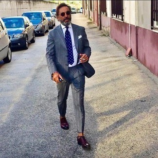 Burgundy Sunglasses Outfits For Men: A charcoal vertical striped suit and burgundy sunglasses are the kind of a tested off-duty combo that you so desperately need when you have zero time. Burgundy leather oxford shoes are guaranteed to give an added touch of class to this getup.