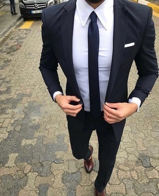 Navy Tie Outfits For Men: A navy suit and a navy tie are a refined combination that every smart guy should have in his sartorial collection. If you need to effortlessly dial down this outfit with footwear, why not introduce a pair of burgundy leather oxford shoes to the equation?