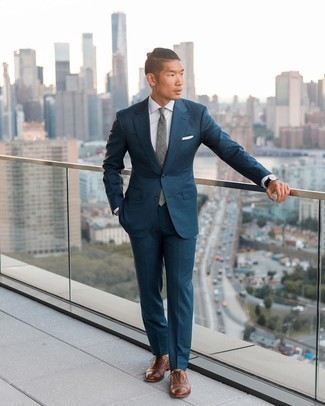 Navy Suit Outfits: You're looking at the solid proof that a navy suit and a white dress shirt are amazing when matched together in a refined look for today's man. When it comes to shoes, throw brown leather oxford shoes in the mix.