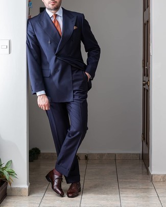 Orange Polka Dot Tie Outfits For Men: You'll be amazed at how easy it is to get dressed this way. Just a navy suit paired with an orange polka dot tie. For times when this ensemble is just too much, dress it down by rounding off with a pair of dark brown leather oxford shoes.