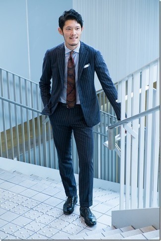 Navy Paisley Tie Outfits For Men: You're looking at the hard proof that a navy vertical striped suit and a navy paisley tie look awesome when paired up in an elegant look for today's gent. Look at how nice this outfit goes with navy leather oxford shoes.