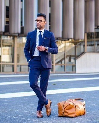 Tobacco Leather Holdall Outfits For Men: This relaxed casual pairing of a navy suit and a tobacco leather holdall is a goofproof option when you need to look dapper in a flash. Serve a little outfit-mixing magic by finishing with tobacco leather oxford shoes.