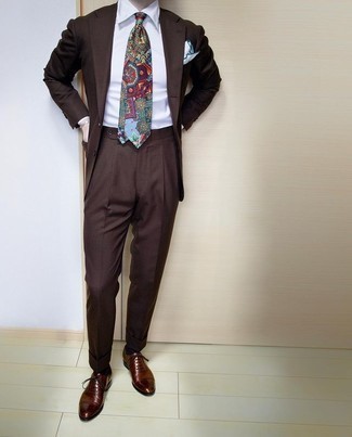 Multi colored Print Tie Outfits For Men: Loving the way this combination of a dark brown suit and a multi colored print tie immediately makes any gent look sharp and polished. And if you want to immediately dress down your look with one item, introduce a pair of dark brown leather oxford shoes to this look.