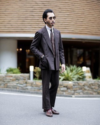 Dark Brown Vertical Striped Suit Outfits: A dark brown vertical striped suit and a white vertical striped dress shirt are absolute wardrobe heroes if you're picking out a stylish wardrobe that holds to the highest menswear standards. Dark brown leather tassel loafers are a nice pick to complete this outfit.