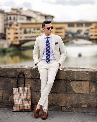 Beige Print Canvas Tote Bag Outfits For Men: Such pieces as a white suit and a beige print canvas tote bag are an easy way to introduce effortless cool into your day-to-day outfit choices. To introduce a little flair to your ensemble, add a pair of brown suede tassel loafers to the mix.