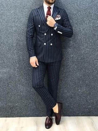 Burgundy Leather Loafers Outfits For Men: Go for a navy vertical striped suit and a white dress shirt for masculine sophistication with a modern take. Let your styling skills truly shine by complementing your look with burgundy leather loafers.