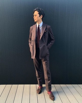 Dark Brown Vertical Striped Suit Outfits: You're looking at the irrefutable proof that a dark brown vertical striped suit and a white dress shirt look amazing when worn together in a refined ensemble for today's gent. A pair of brown suede tassel loafers is a nice idea to finish this outfit.