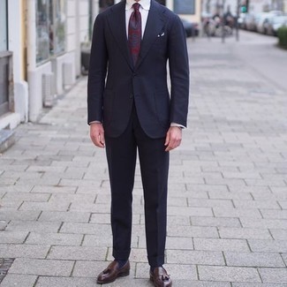 Burgundy Tie Outfits For Men: You'll be amazed at how super easy it is to throw together this elegant ensemble. Just a navy suit paired with a burgundy tie. Why not introduce dark brown leather tassel loafers to the mix for a more relaxed finish?