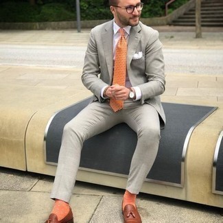 Yellow Print Tie Outfits For Men: You're looking at the solid proof that a grey suit and a yellow print tie look amazing when worn together in a refined look for today's gent. Got bored with this look? Let brown leather tassel loafers mix things up a bit.