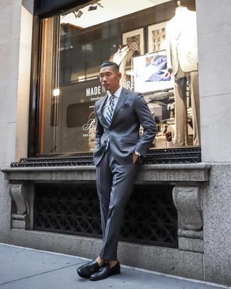 Light Blue Tie Outfits For Men: Serve people a head-turning look in a charcoal suit and a light blue tie. To infuse a dose of stylish casualness into this outfit, complement this getup with a pair of black leather tassel loafers.