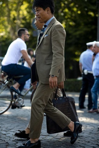 Olive Suit Outfits: Consider teaming an olive suit with a light blue chambray dress shirt if you're going for a proper, fashionable getup. Hesitant about how to round off? Complete your outfit with a pair of black leather tassel loafers to change things up a bit.