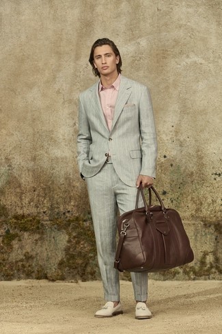 Dark Brown Leather Holdall Outfits For Men: Look sharp yet laid-back by wearing a grey vertical striped suit and a dark brown leather holdall. White canvas tassel loafers will breathe an extra dose of style into an otherwise utilitarian look.
