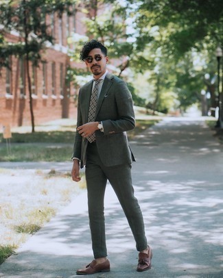 Dark Green Suit Outfits: To look clean and smart, choose a dark green suit and a grey vertical striped dress shirt. A pair of dark brown leather tassel loafers can integrate seamlessly within a myriad of outfits.