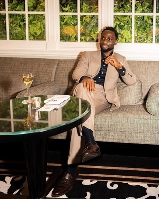 Tassel Loafers Outfits: For an outfit that's dapper and envy-worthy, consider teaming a tan suit with a navy dress shirt. A pair of tassel loafers will give an easy-going feel to this look.