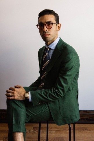 Dark Green Suit Outfits: This combo of a dark green suit and a light blue vertical striped dress shirt speaks elegance and effortless refinement.