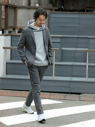Grey Wool Suit Casual Outfits: Pair a grey wool suit with a grey hoodie to assemble an effortlessly stylish and modern-looking ensemble. Grey athletic shoes are guaranteed to bring an air of stylish effortlessness to this outfit.