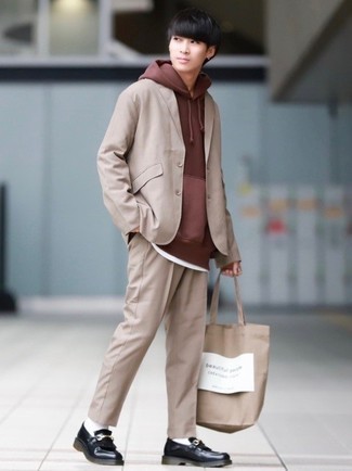 Beige Print Canvas Tote Bag Outfits For Men: A tan suit and a beige print canvas tote bag combined together are a perfect match. Amp up this ensemble by rounding off with black fringe leather loafers.