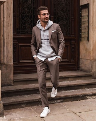 Grey Hoodie Outfits For Men: Wear a grey hoodie and a brown suit to achieve a casually sleek and modern-looking outfit. A good pair of white canvas low top sneakers is an effective way to punch up your ensemble.
