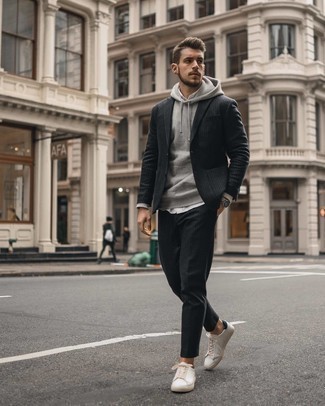 Black Vertical Striped Suit Outfits: A black vertical striped suit and a grey hoodie matched together are a perfect match. Send an otherwise all-too-safe look down a more relaxed path by rocking a pair of white and black leather low top sneakers.