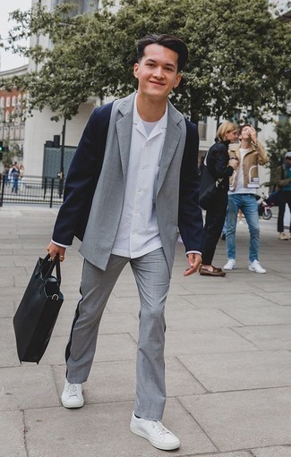 Grey Suit Outfits: This pairing of a grey suit and a white long sleeve shirt is a lifesaver when you need to look extra stylish and classy. Want to play it down on the shoe front? Add white leather low top sneakers to the equation for the day.