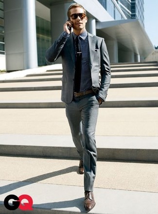 A grey suit and a white and navy gingham long sleeve shirt make for the ultimate sophisticated style. Get a bit experimental in the footwear department and introduce a pair of dark brown leather derby shoes to this look.