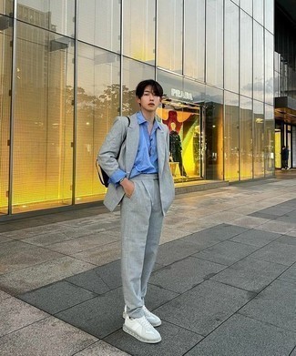 Grey Suit Outfits: You'll be amazed at how very easy it is to pull together this sophisticated outfit. Just a grey suit paired with a light blue long sleeve shirt. For something more on the daring side to round off this look, throw in white leather low top sneakers.