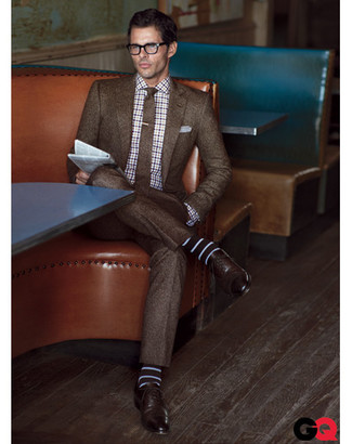 A brown wool suit looks especially refined when worn with a white and navy plaid long sleeve shirt for an outfit worthy of a modern dandy. You can get a little creative with footwear and smarten up this outfit by finishing with a pair of dark brown leather oxford shoes.