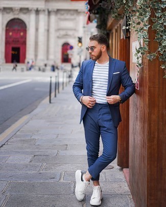 Blue Suit Outfits: Teaming a blue suit with a white and blue horizontal striped long sleeve t-shirt is a nice idea for a casually stylish ensemble. Finish off with a pair of white and black leather low top sneakers to transform your look.