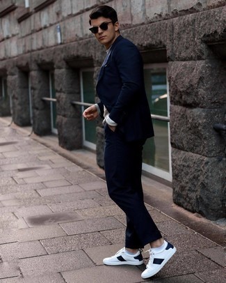 Men's Navy Suit, Grey Long Sleeve T-Shirt, White and Navy Leather Low Top Sneakers, Black Sunglasses