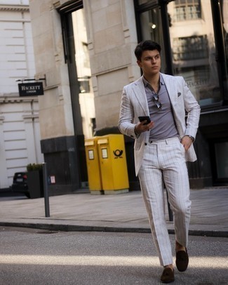 White Vertical Striped Suit Outfits: This pairing of a white vertical striped suit and a grey polo is proof that a pared down outfit doesn't have to be boring. Complete this ensemble with a pair of dark brown suede tassel loafers to completely switch up the look.