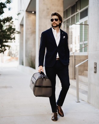 Brown Canvas Holdall Outfits For Men: A navy suit and a brown canvas holdall make for the ultimate relaxed casual ensemble for any man. To give your overall look a dressier aesthetic, complement your look with dark brown leather oxford shoes.