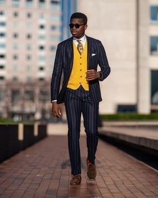 Yellow Sweater Vest Outfits For Men: This combo of a yellow sweater vest and a navy vertical striped suit is a life saver when you need to look like a maverick in the menswear department. Add brown suede tassel loafers to your look and ta-da: the outfit is complete.