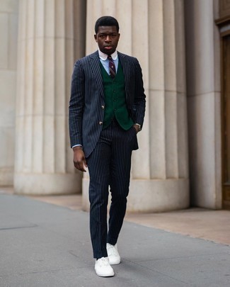 Burgundy Horizontal Striped Tie Outfits For Men: Go for a navy vertical striped suit and a burgundy horizontal striped tie to look like a true fashion maverick. Feeling experimental today? Change up your ensemble by rounding off with a pair of white canvas low top sneakers.