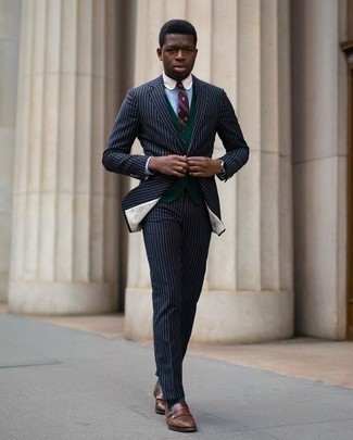 Olive Sweater Vest Outfits For Men: For a look that's polished and truly wow-worthy, rock an olive sweater vest with a navy vertical striped suit. Brown fringe leather loafers tie the ensemble together.